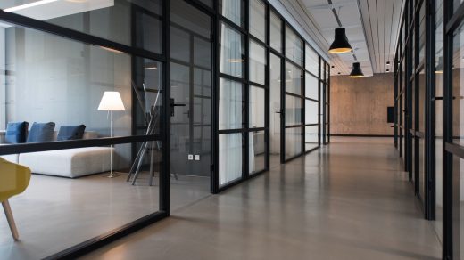 business office space hallway between glass-panel doors