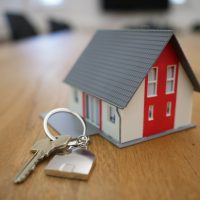 Search for Property white and red wooden house miniature on brown table