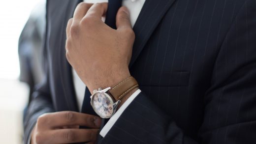 hiring an economist man wearing watch with black suit