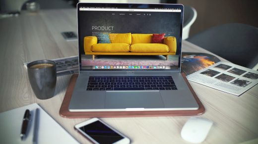 Boost Your Online Business turned on MacBook Pro beside gray mug