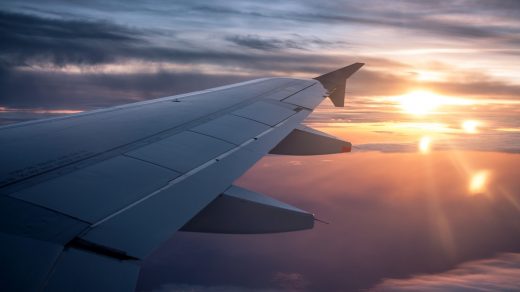 white airplane wing during sunset