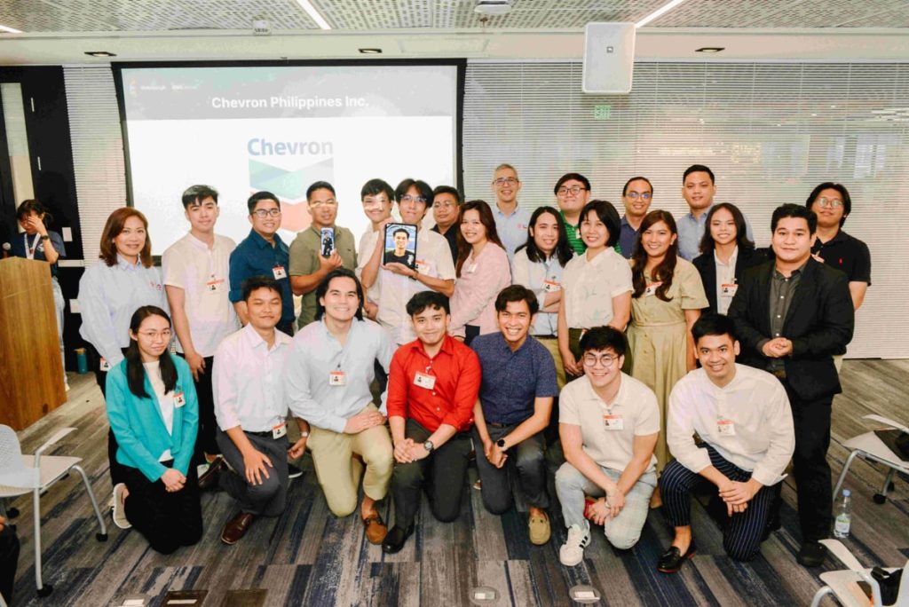 Chevron scholars and executives during the AWS re/Start program graduation ceremony