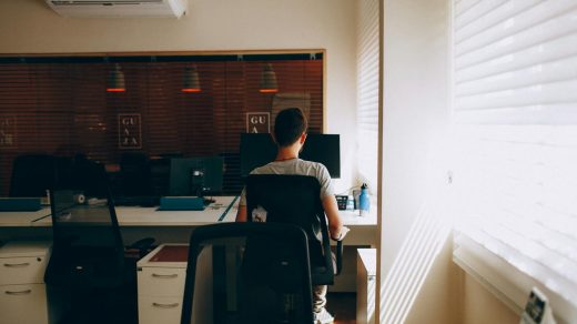 Person in Gray Shirt Sitting on Computer Chair