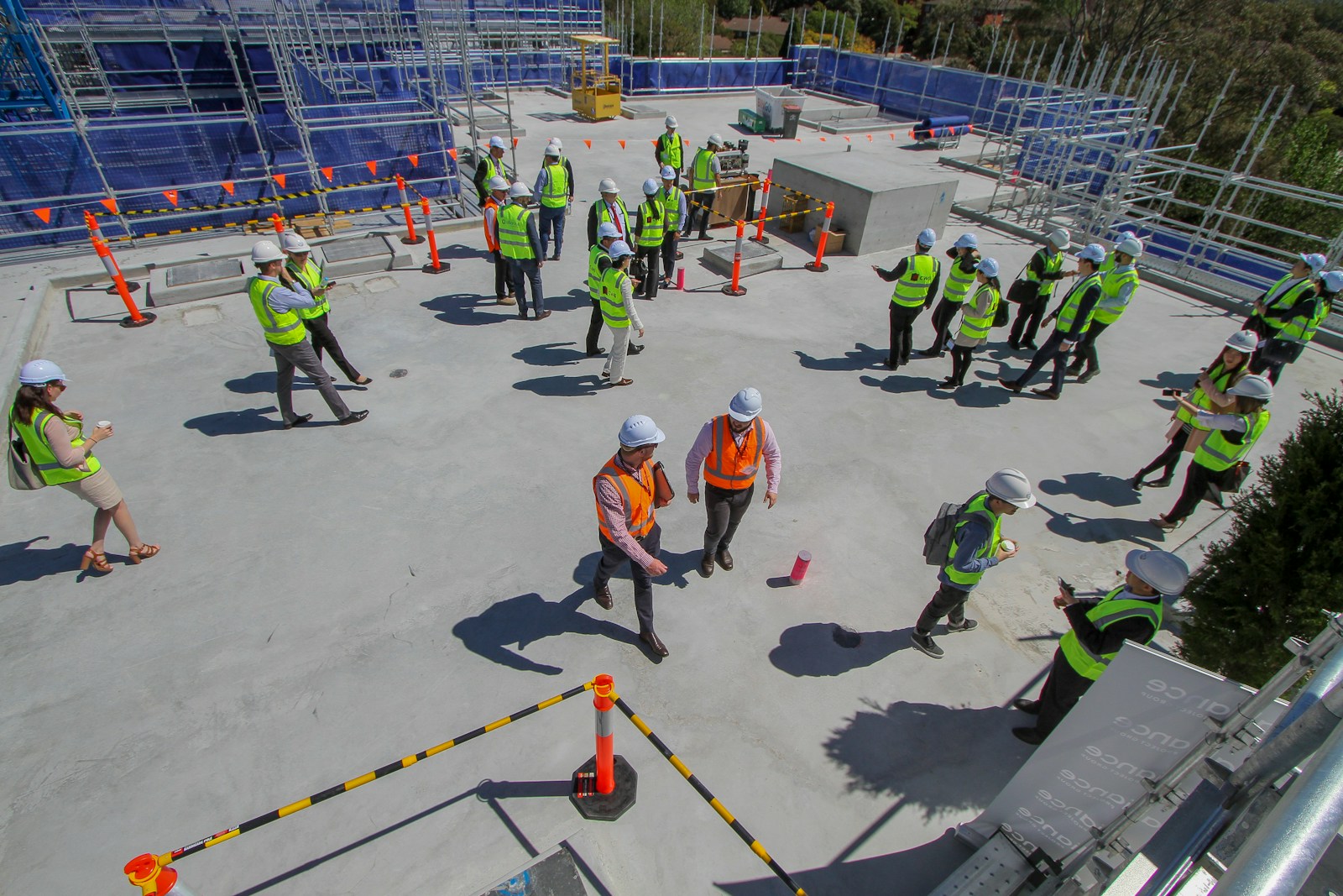 a group of construction workers standing on top of a building