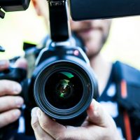 Person Holding Canon Dslr Camera Close-up Photo