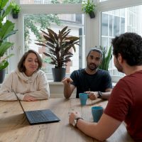 woman in white hijab sitting beside man in red crew neck t-shirt